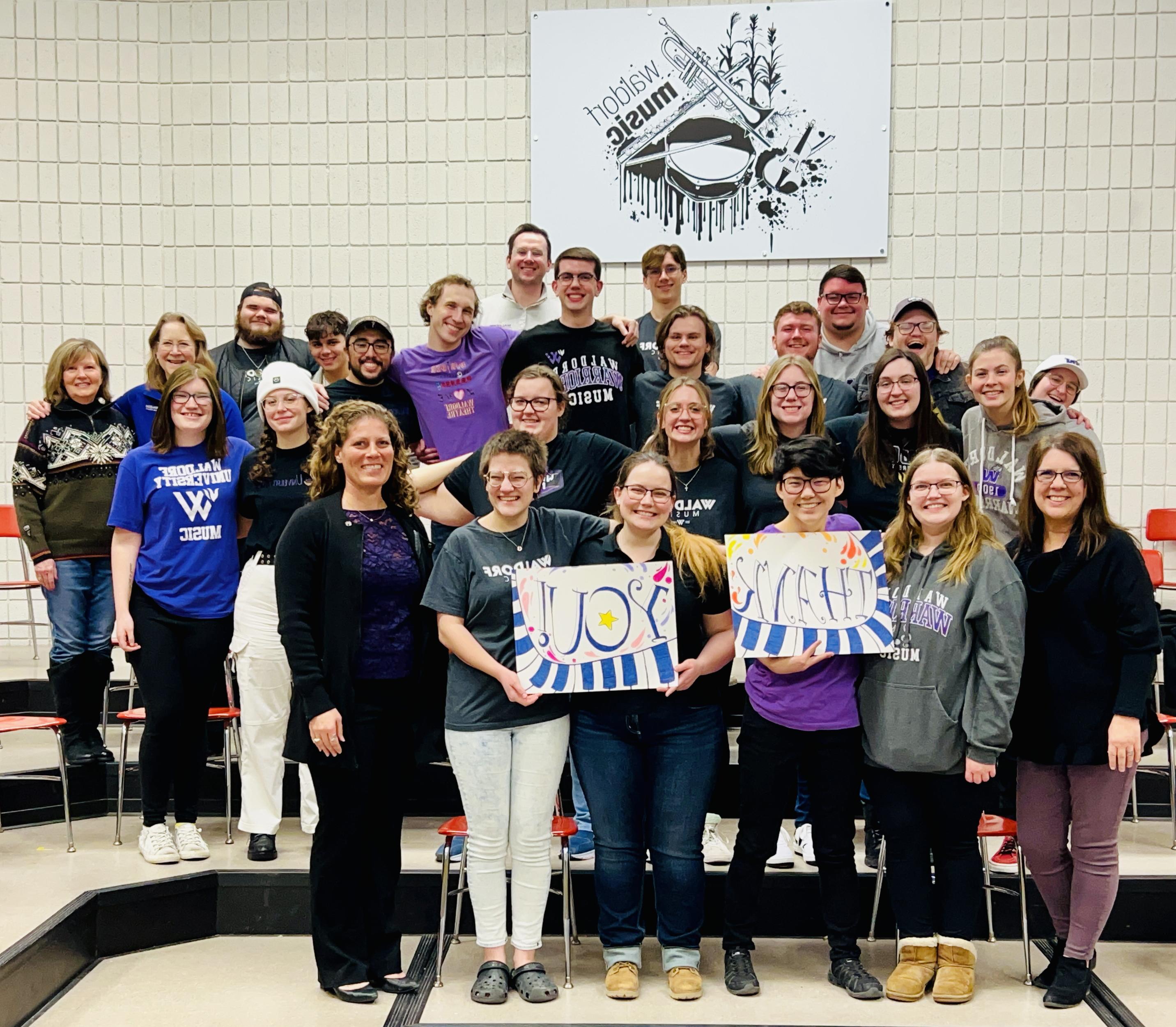 Waldorf Choir students and professors holding "Thank You" sign